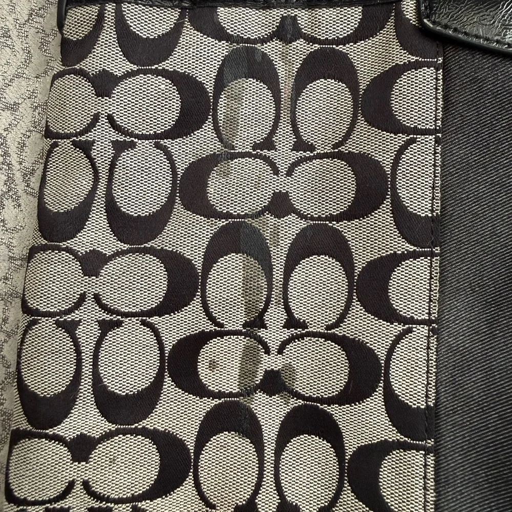 Coach Signature Stripe File Bag features a black and gray monogram canvas